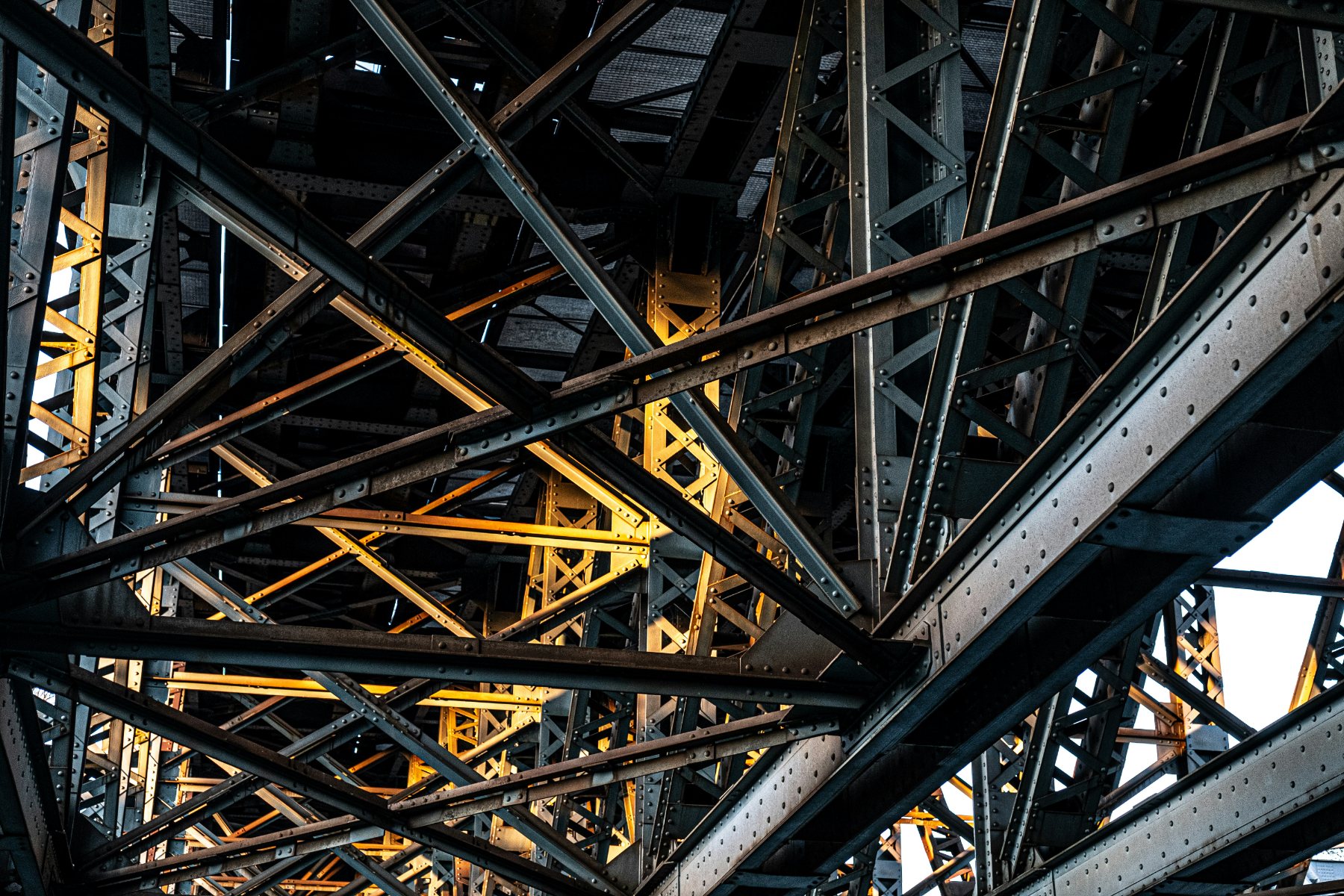 Riveted steel truss members beneath a bridge deck